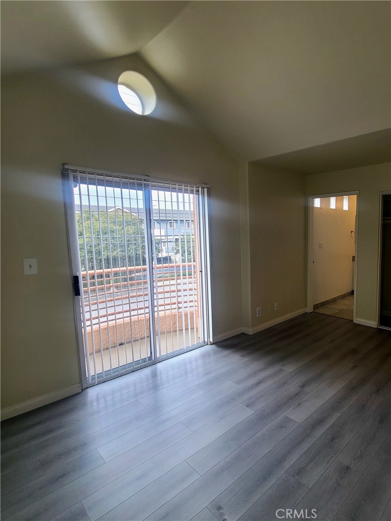 5060 Kester Avenue, Unit 208 Sherman Oaks, CA 91403 - Photo 12 of 31 a view of an empty room with wooden floor and a window