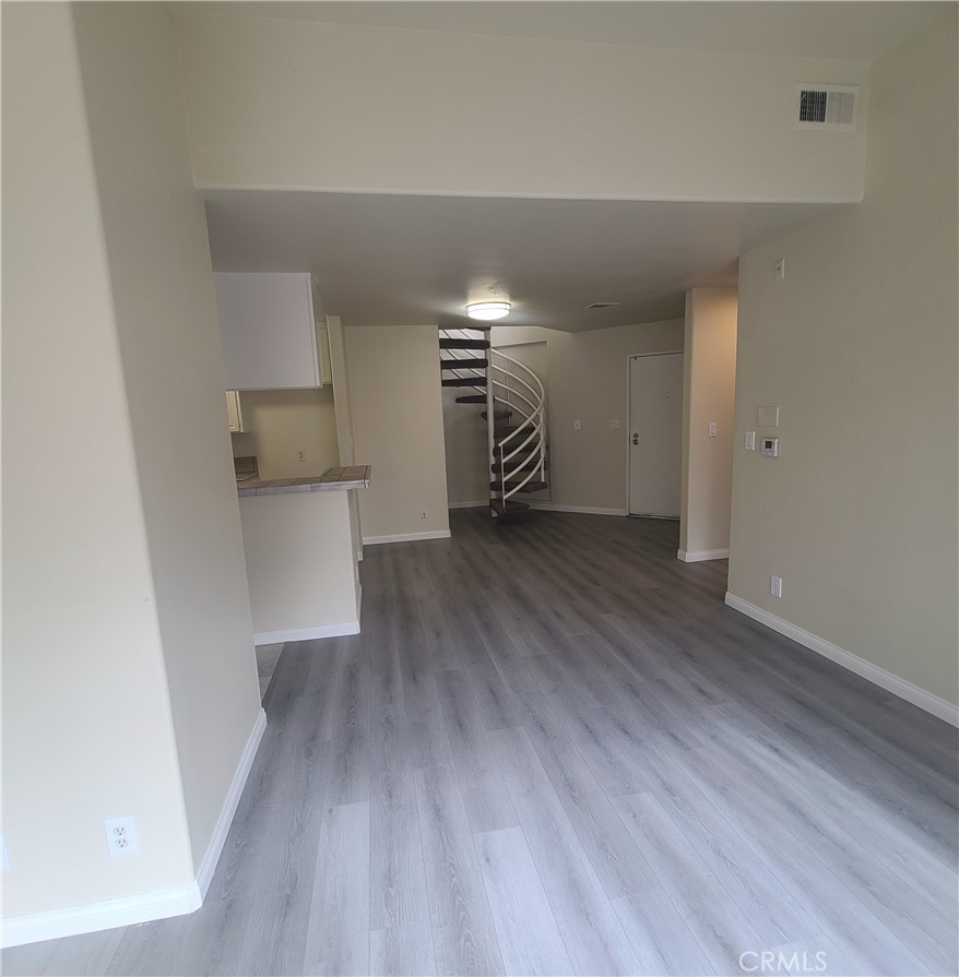 5060 Kester Avenue, Unit 208 Sherman Oaks, CA 91403 - Photo 16 of 31 a view of empty room with wooden floor and fireplace