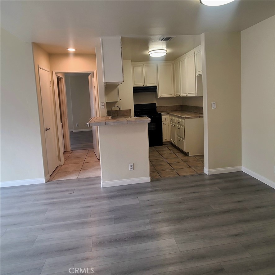 5060 Kester Avenue, Unit 208 Sherman Oaks, CA 91403 - Photo 3 of 31 a view of kitchen with cabinets appliances and wooden floor