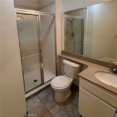 a bathroom with a granite countertop toilet sink and shower