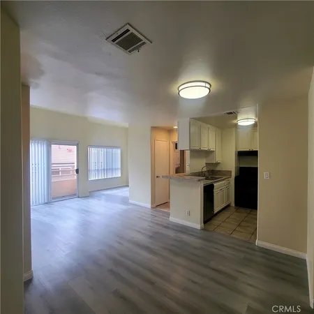 a kitchen with a refrigerator and a sink