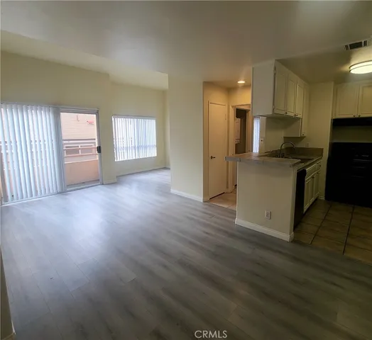 a kitchen with granite countertop a stove and a refrigerator