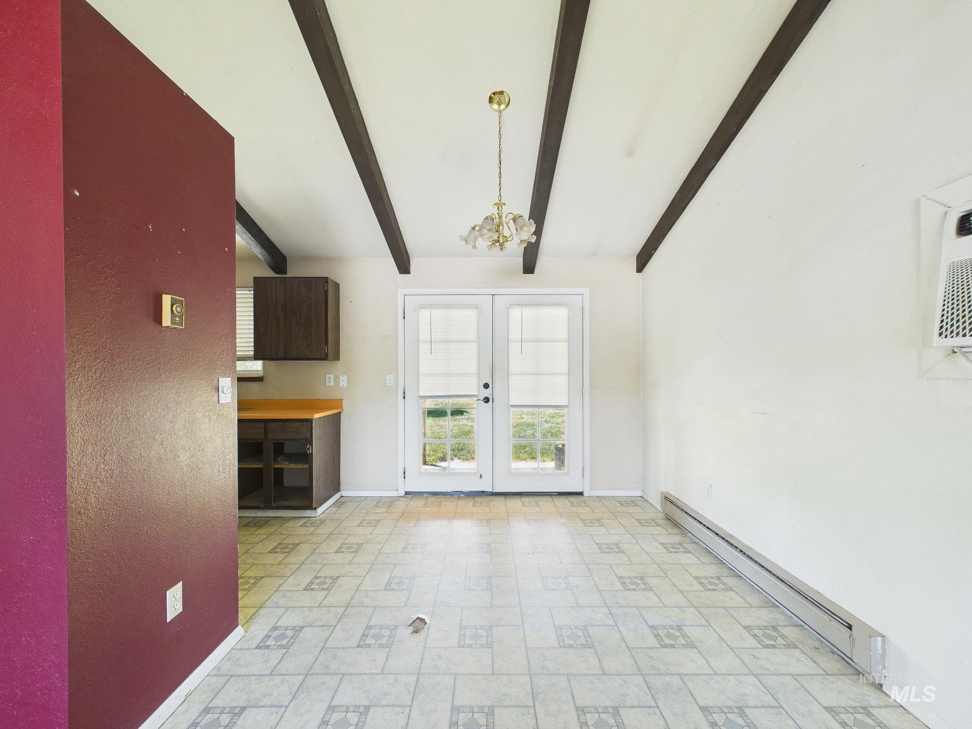 1527 North Plaza Road Emmett, ID 83617 - Photo 7 of 33 Room featuring exposed ceiling beams, white walls, and pattern-tile flooring