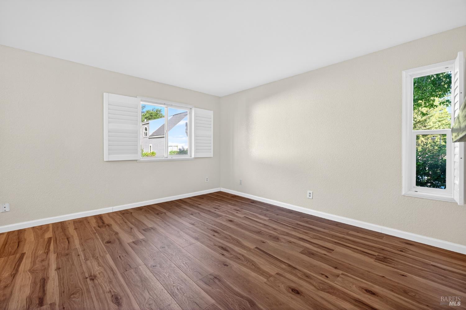 2757 Lakeview Drive Santa Rosa, CA 95405 - Photo 16 of 54 an empty room with wooden floor and windows