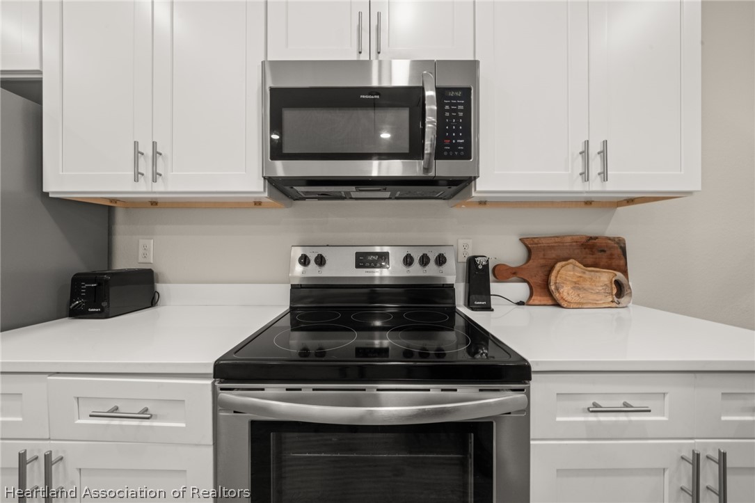 4734 Haw Branch Road, Unit 110 Sebring, FL 33875 - Photo 13 of 50 a stove top oven sitting inside of a kitchen