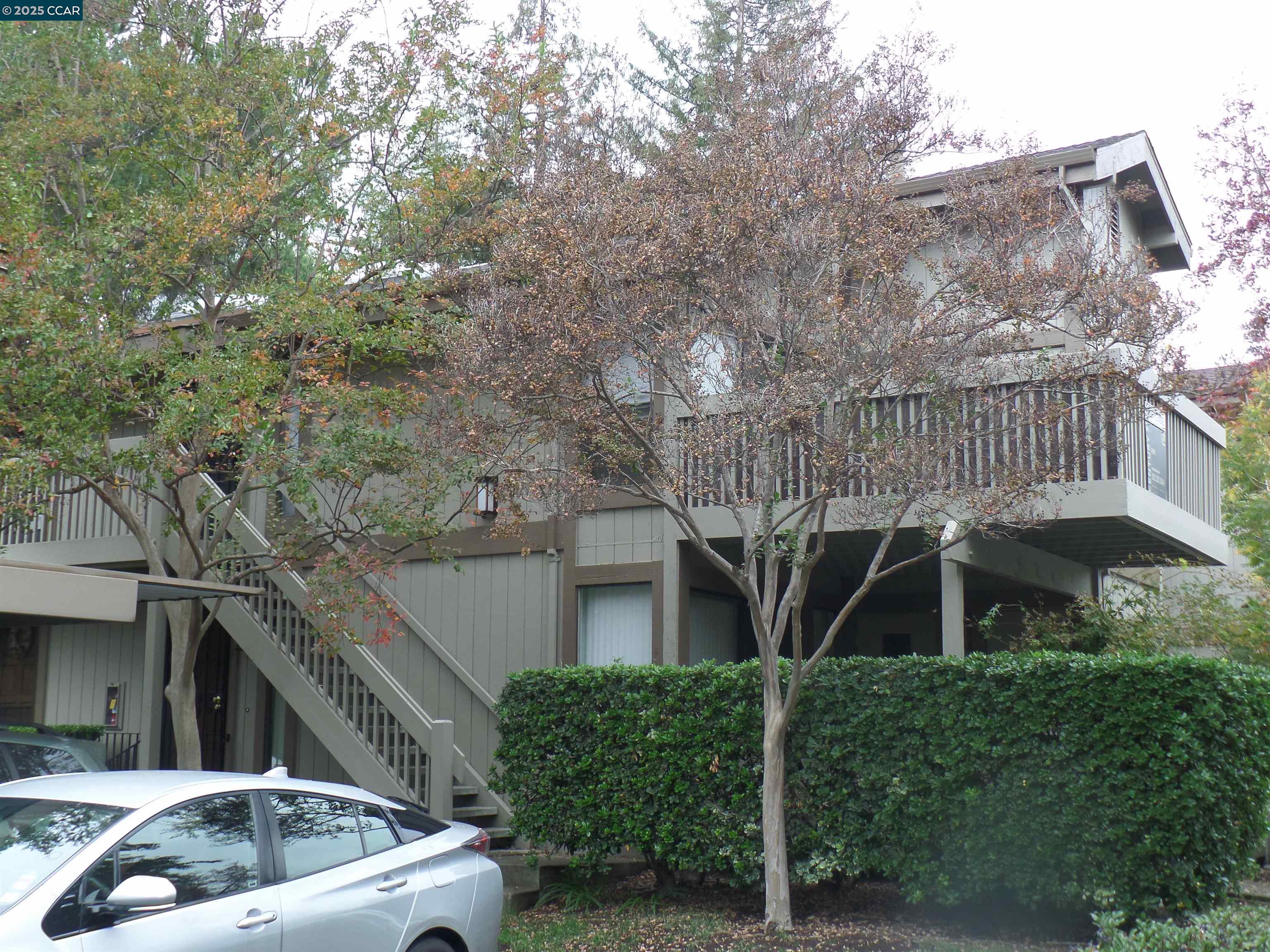 1544 Bailey Road, Unit 6 Concord, CA 94521 - Photo 2 of 18 a front view of a house with garden