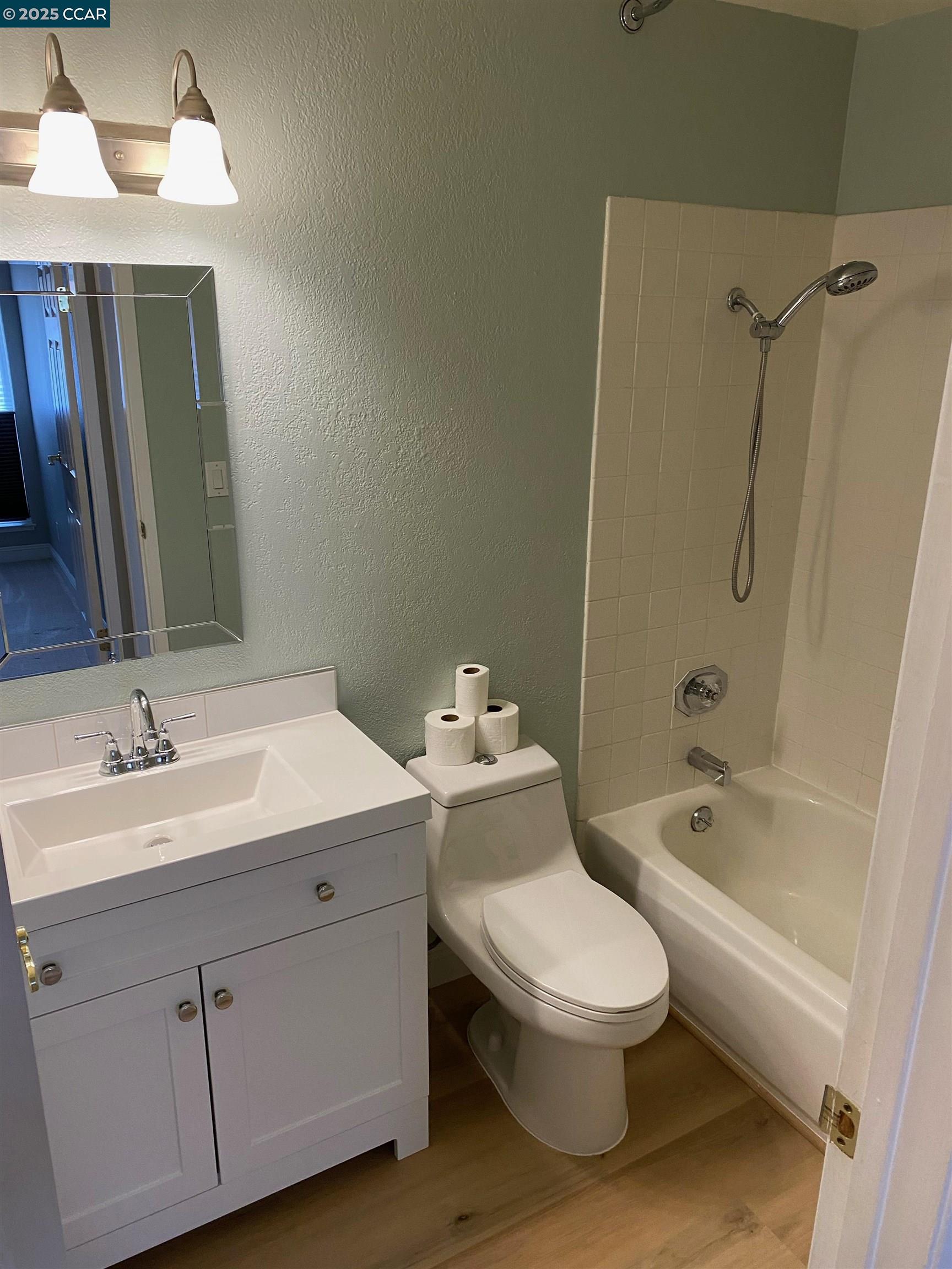 1544 Bailey Road, Unit 6 Concord, CA 94521 - Photo 10 of 18 a bathroom with a toilet a sink a mirror a bathtub and shower
