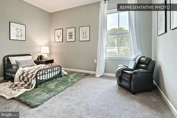 a bedroom with a bed lamp and a window