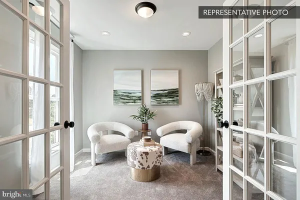 a bedroom with furniture and a large window