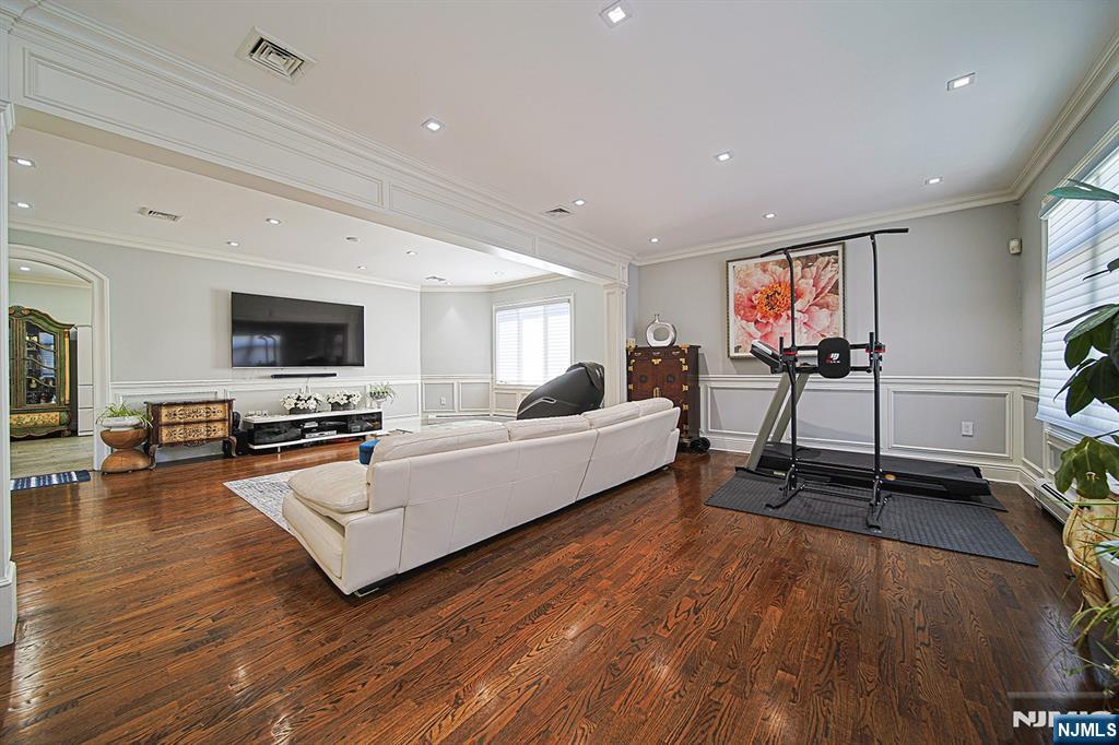 897 Virgil Avenue Ridgefield, NJ 07657 - Photo 13 of 50 a living room with furniture flat screen tv and wooden floor