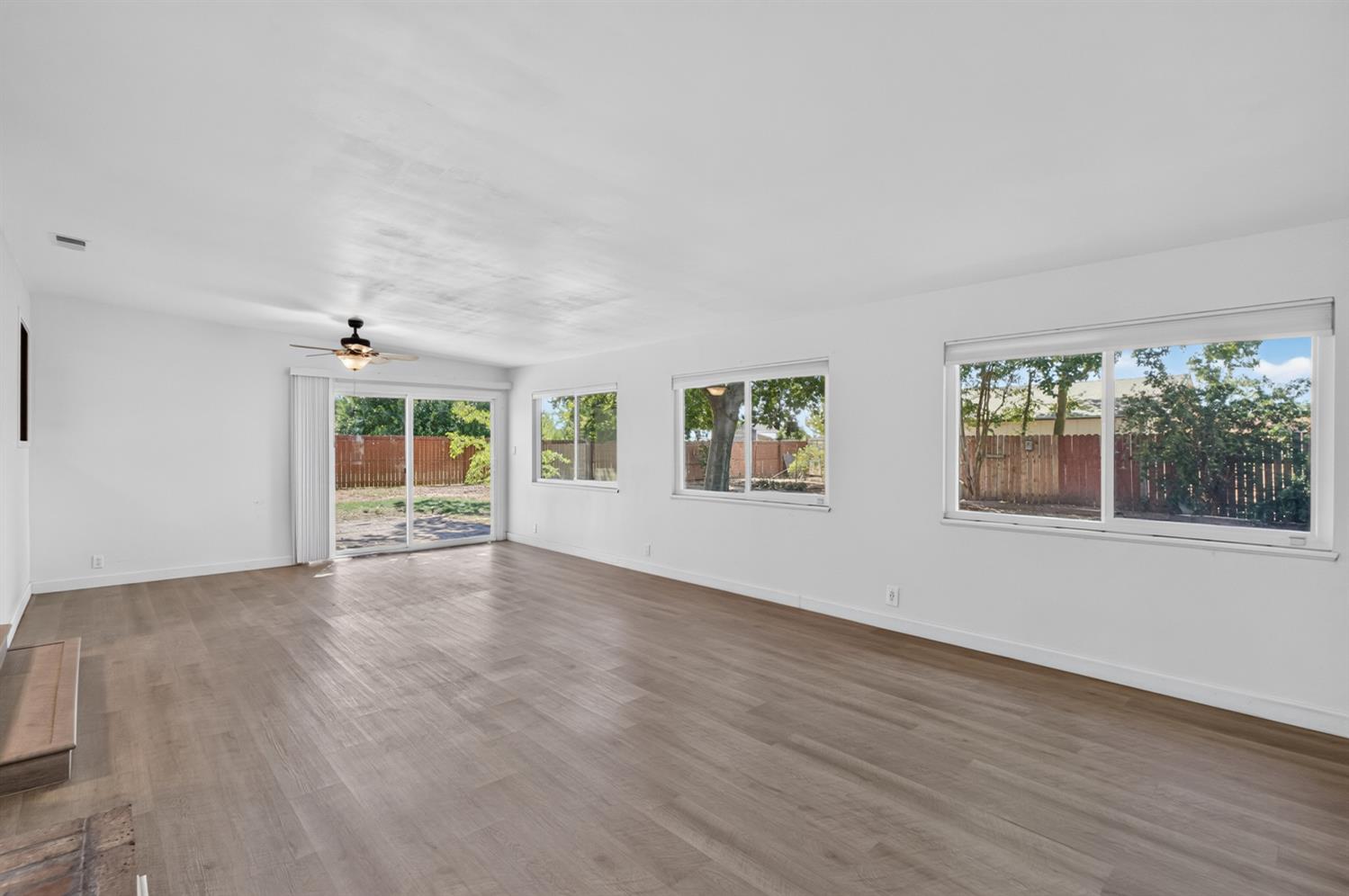 10700 Calvine Road Elk Grove, CA 95830 - Photo 26 of 73 a view of an empty room with a window and wooden floor