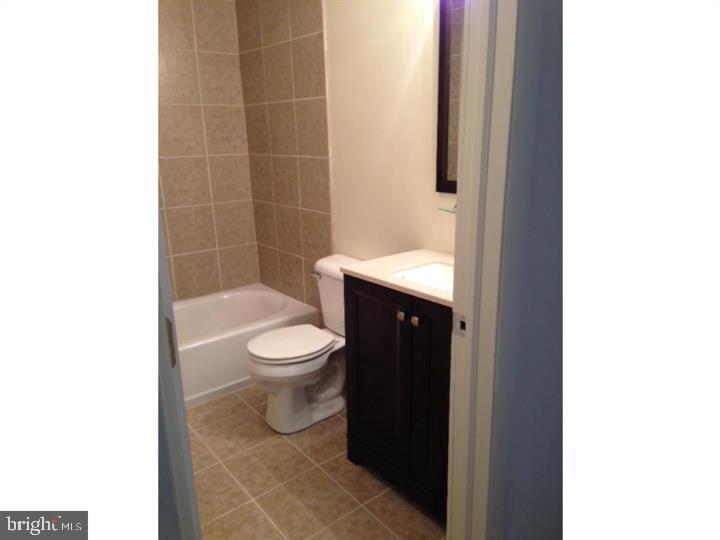 95 Linden Avenue, Unit B Pitman, NJ 08071 - Photo 2 of 15 a bathroom with a toilet and a shower