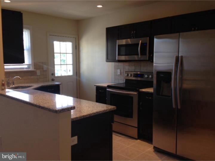 95 Linden Avenue, Unit B Pitman, NJ 08071 - Photo 4 of 15 a kitchen with a sink and refrigerator