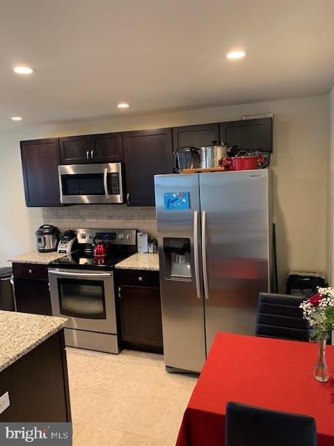 95 Linden Avenue, Unit B Pitman, NJ 08071 - Photo 8 of 15 a kitchen with stainless steel appliances granite countertop a refrigerator sink and stove