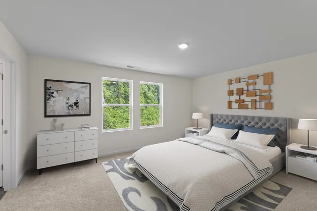 a bedroom with a bed and a large window