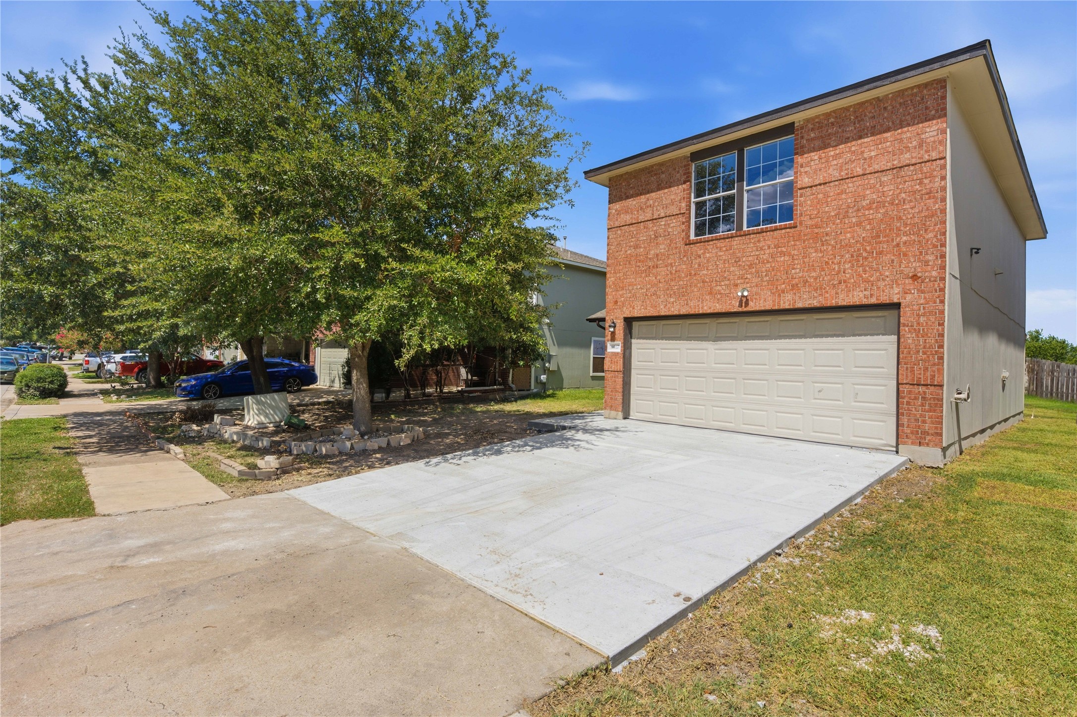 6917 Panda Royle Drive Del Valle, TX 78617 - Photo 2 of 23 A classic brick exterior, complete with an attached garage and a spacious concrete driveway, presents welcoming curb appeal.