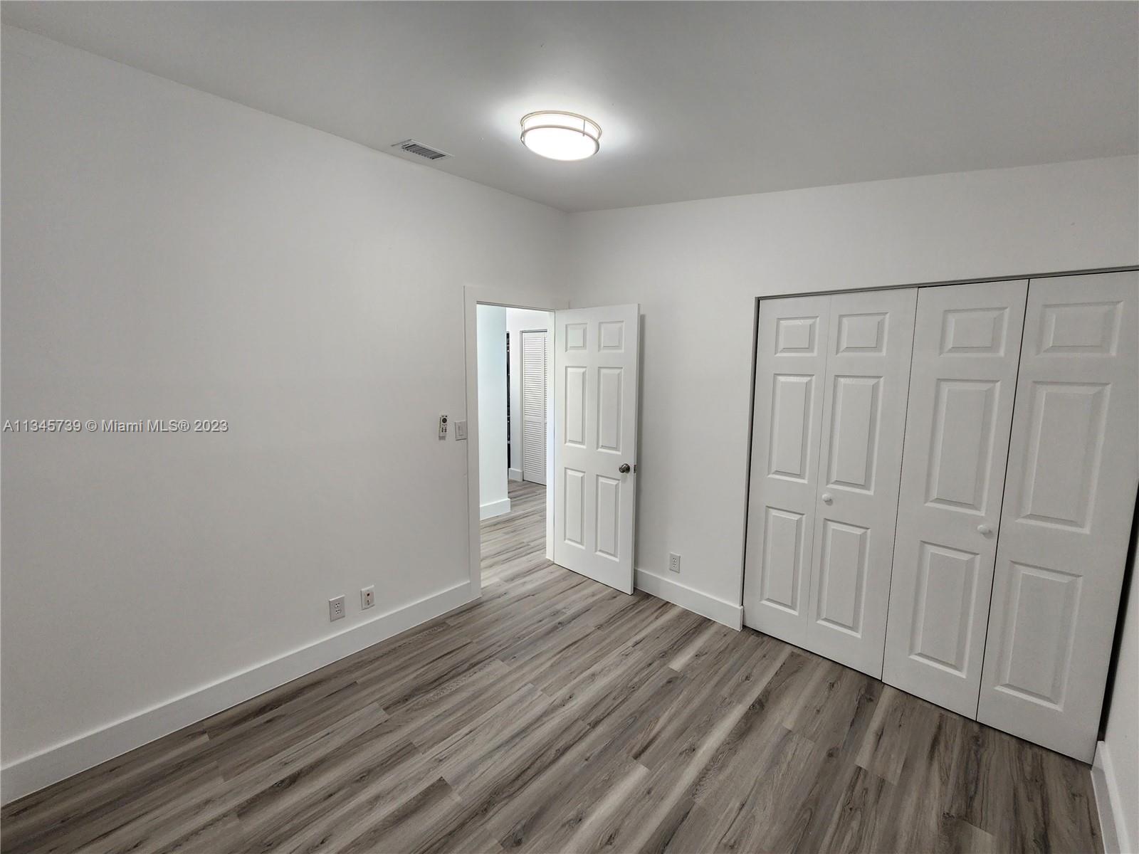 11603 Timbers Way Boca Raton, FL 33428 - Photo 12 of 48 a view of an empty room and wooden floor
