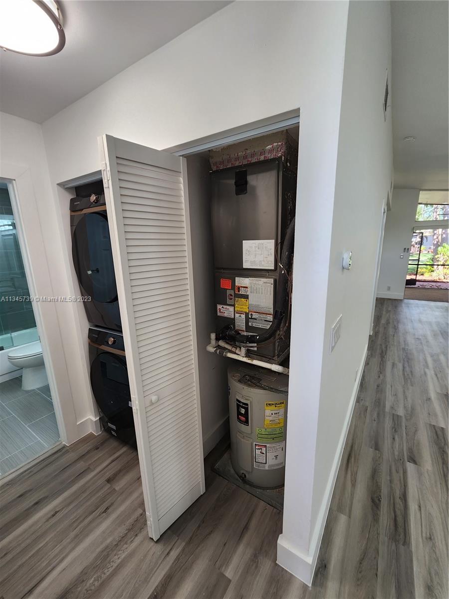 11603 Timbers Way Boca Raton, FL 33428 - Photo 13 of 48 a kitchen with a refrigerator a stove and wooden floor
