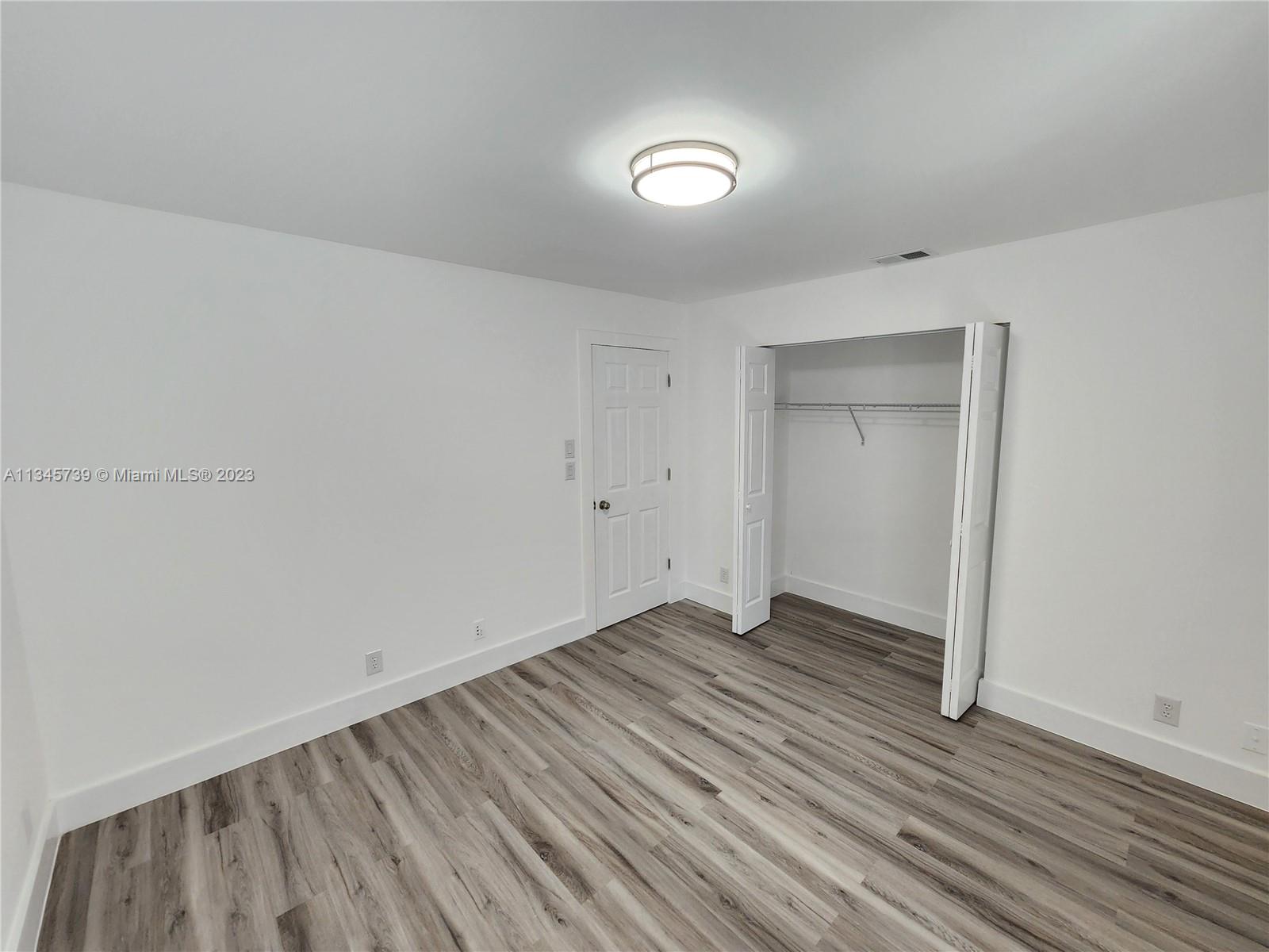 11603 Timbers Way Boca Raton, FL 33428 - Photo 16 of 48 a view of an empty room with wooden floor