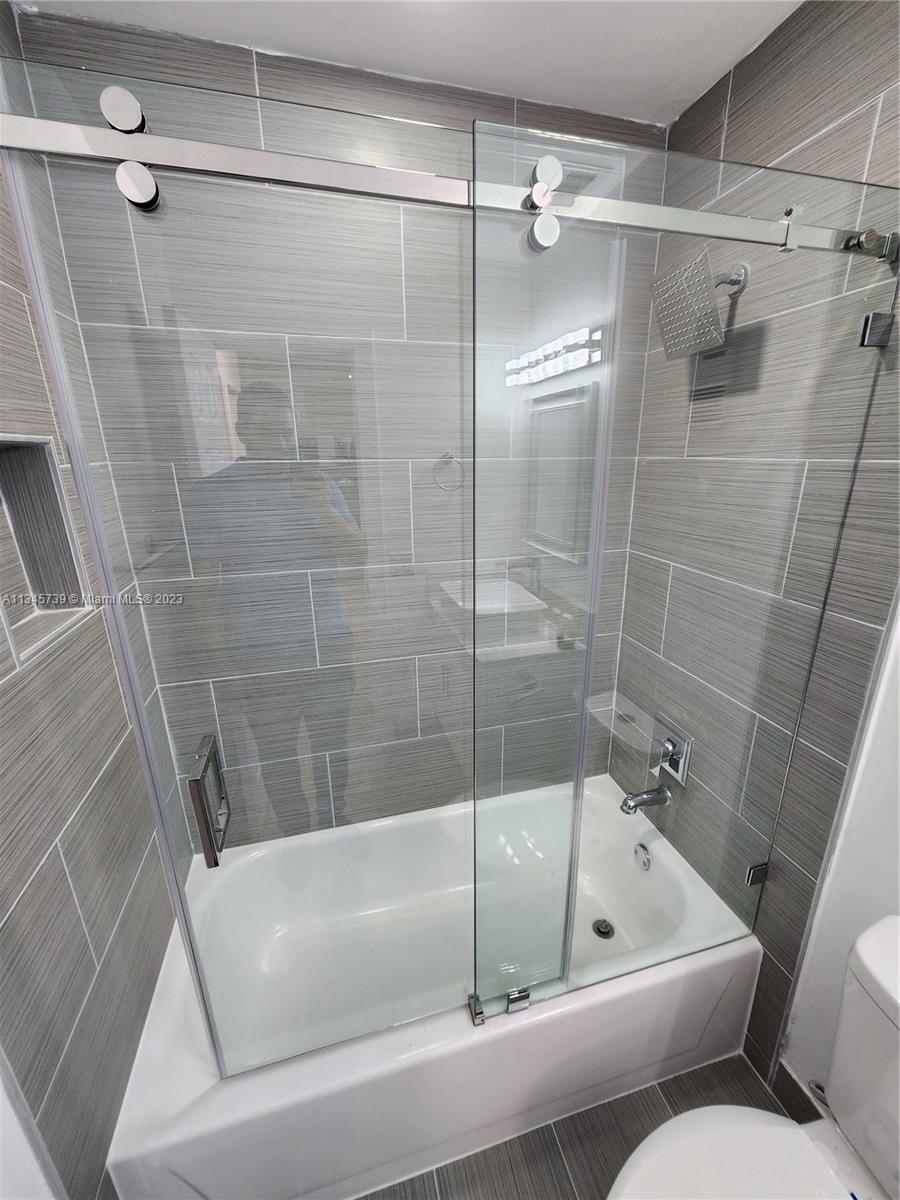 11603 Timbers Way Boca Raton, FL 33428 - Photo 18 of 48 a bathroom with a tub and a shower