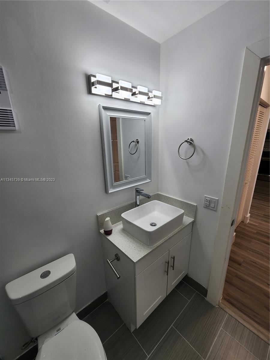 11603 Timbers Way Boca Raton, FL 33428 - Photo 19 of 48 a bathroom with a toilet sink and mirror