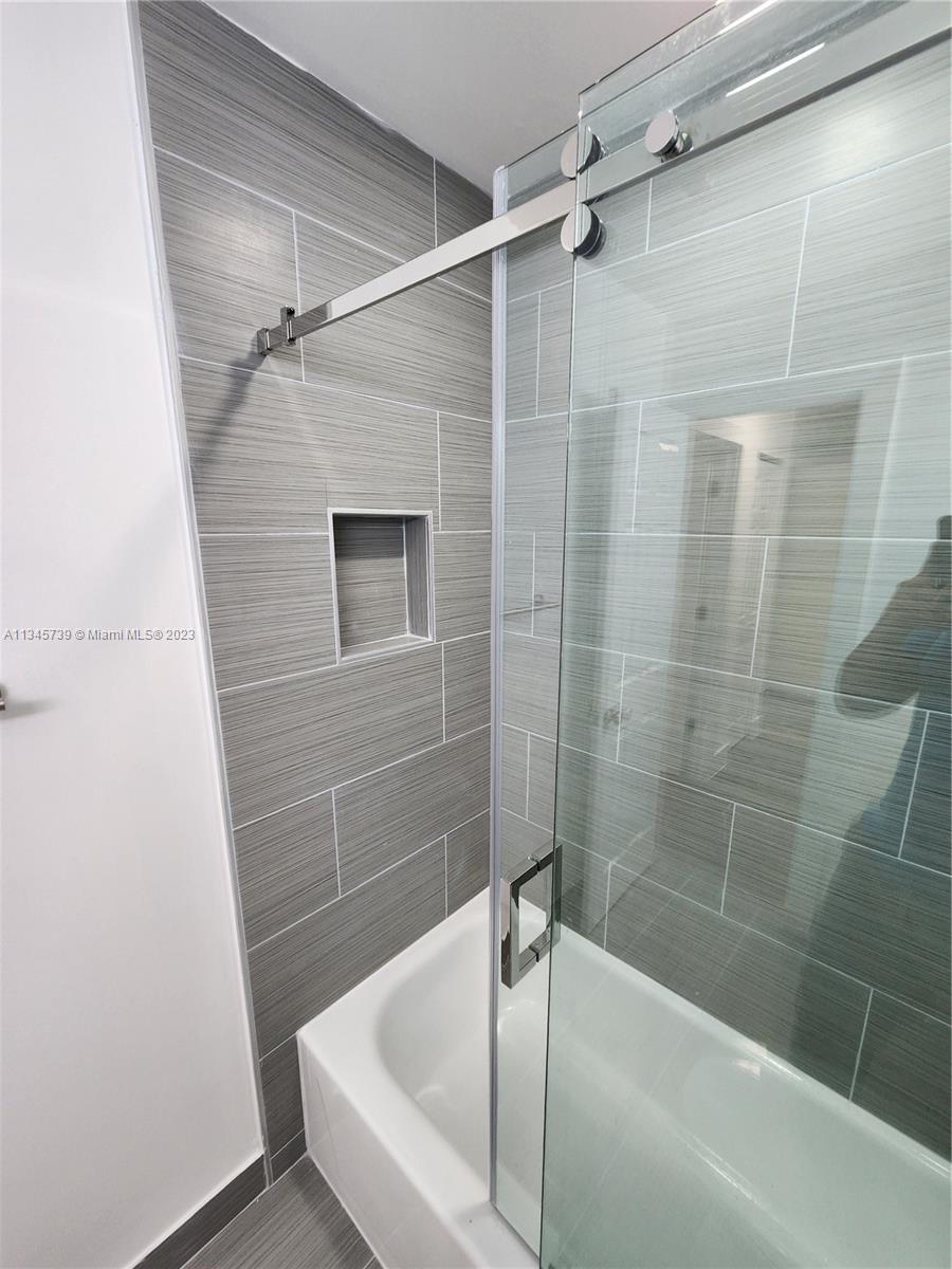 11603 Timbers Way Boca Raton, FL 33428 - Photo 20 of 48 a bathroom with a bathtub and a shower