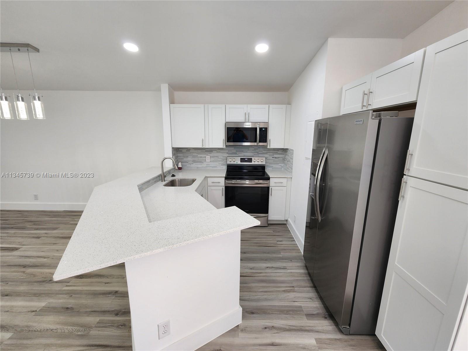 11603 Timbers Way Boca Raton, FL 33428 - Photo 2 of 48 a kitchen with stainless steel appliances a refrigerator sink and microwave