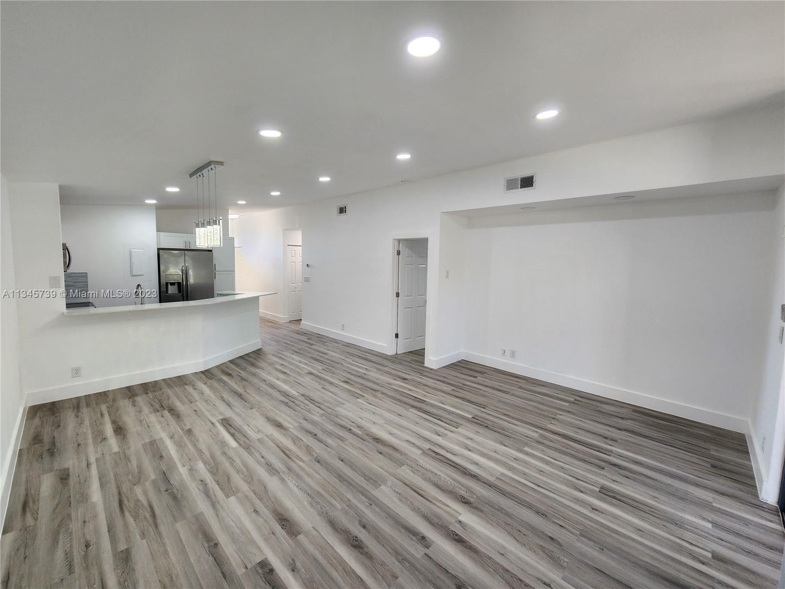 11603 Timbers Way Boca Raton, FL 33428 - Photo 23 of 48 an empty room with wooden floor and windows