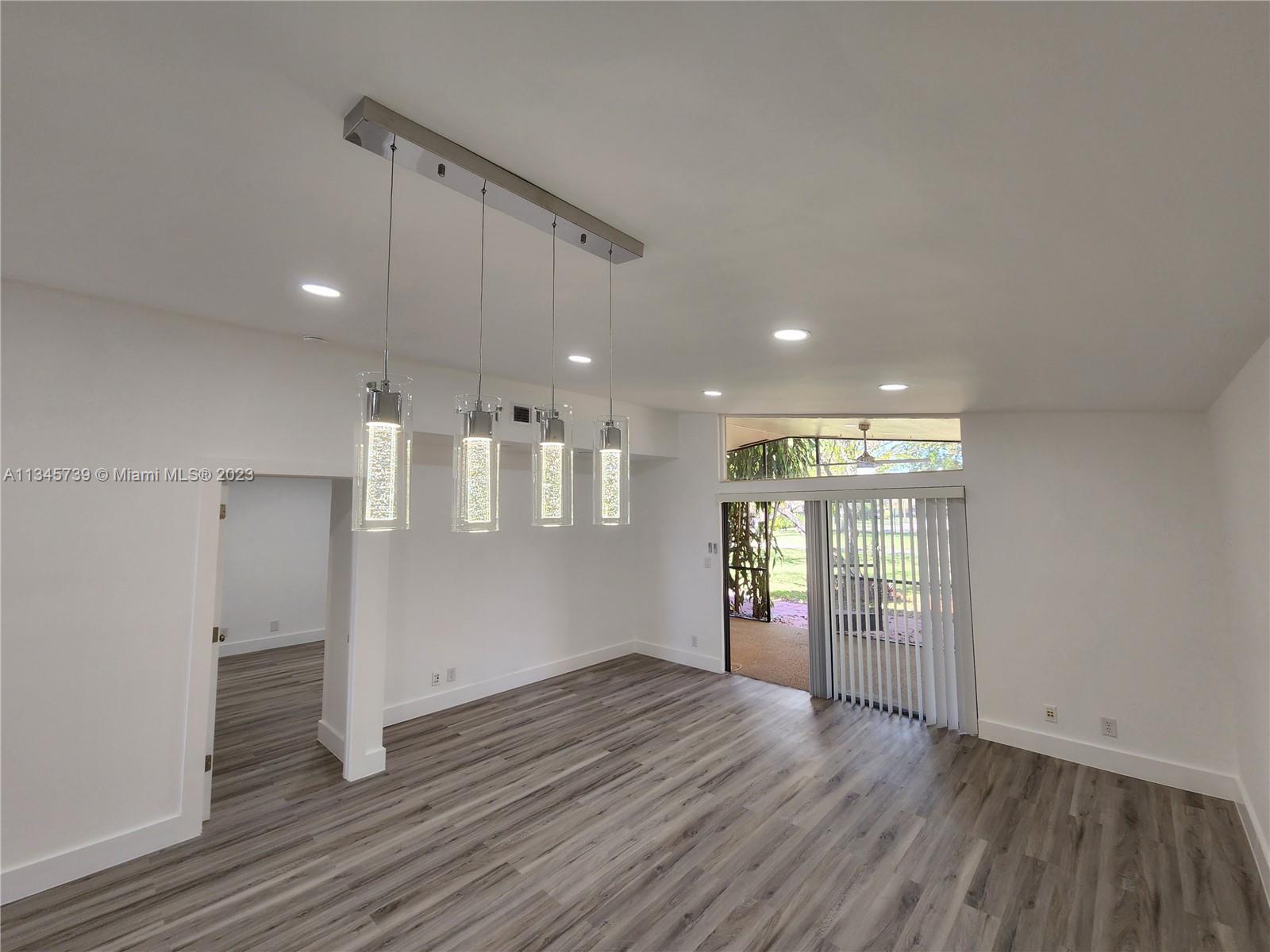 11603 Timbers Way Boca Raton, FL 33428 - Photo 25 of 48 an empty room with wooden floor and entrance
