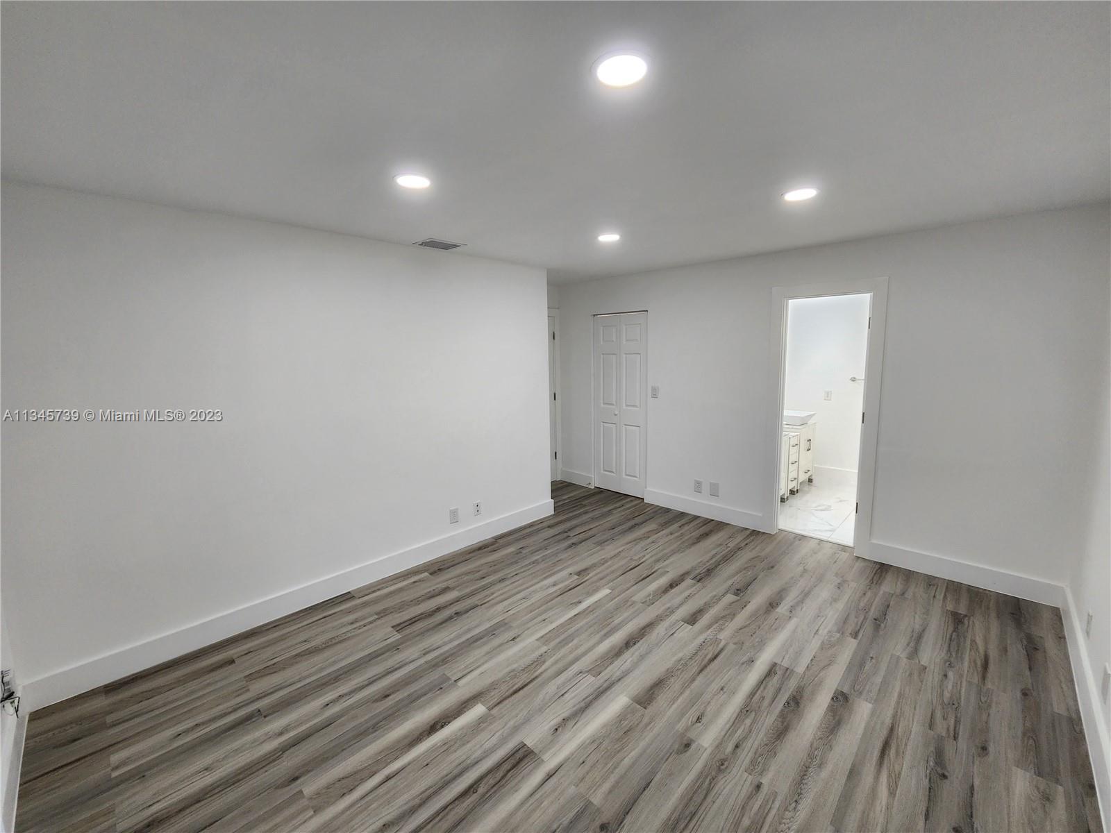 11603 Timbers Way Boca Raton, FL 33428 - Photo 29 of 48 an empty room with wooden floor and windows