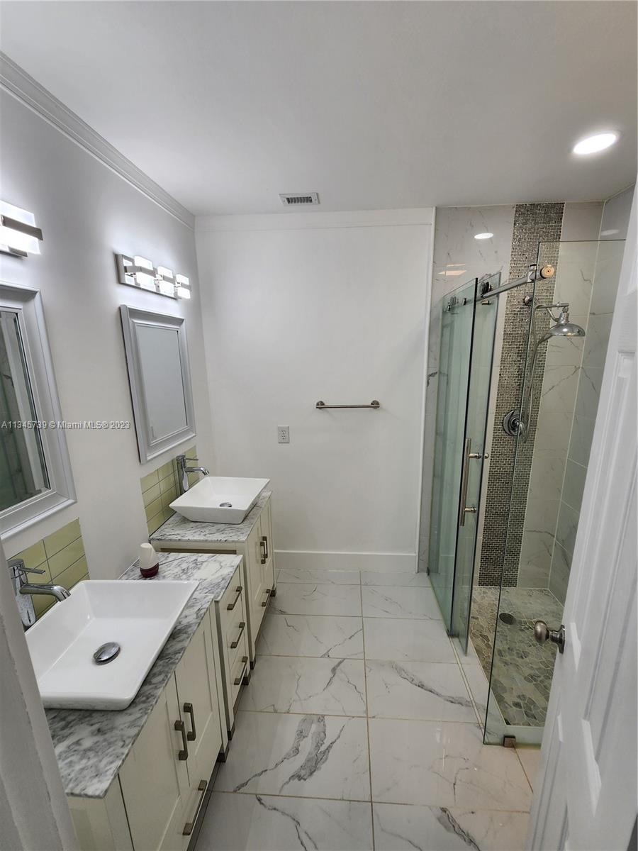 11603 Timbers Way Boca Raton, FL 33428 - Photo 30 of 48 a spacious bathroom with a double vanity sink toilet and shower