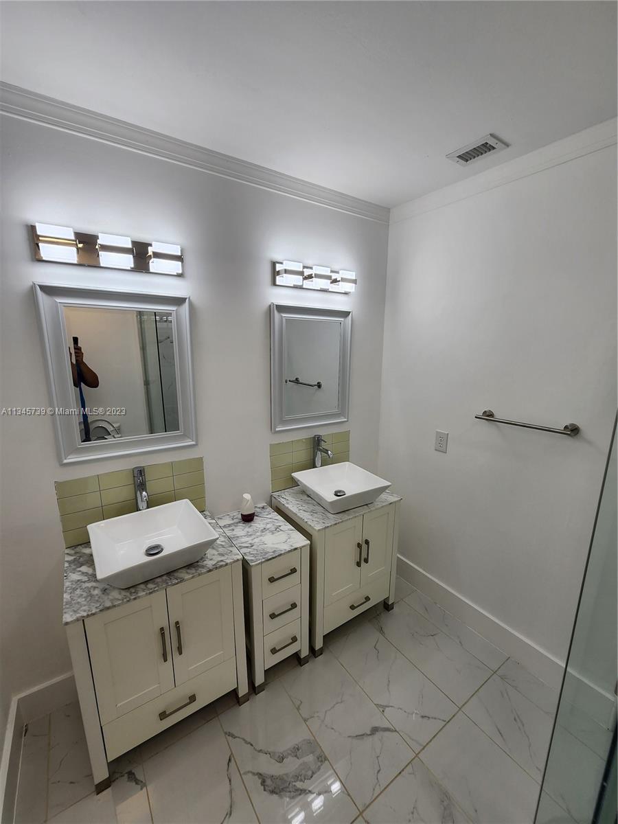 11603 Timbers Way Boca Raton, FL 33428 - Photo 32 of 48 a bathroom with a double vanity sink and mirror