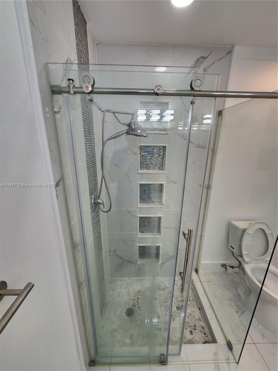 11603 Timbers Way Boca Raton, FL 33428 - Photo 33 of 48 a bathroom with a glass shower door