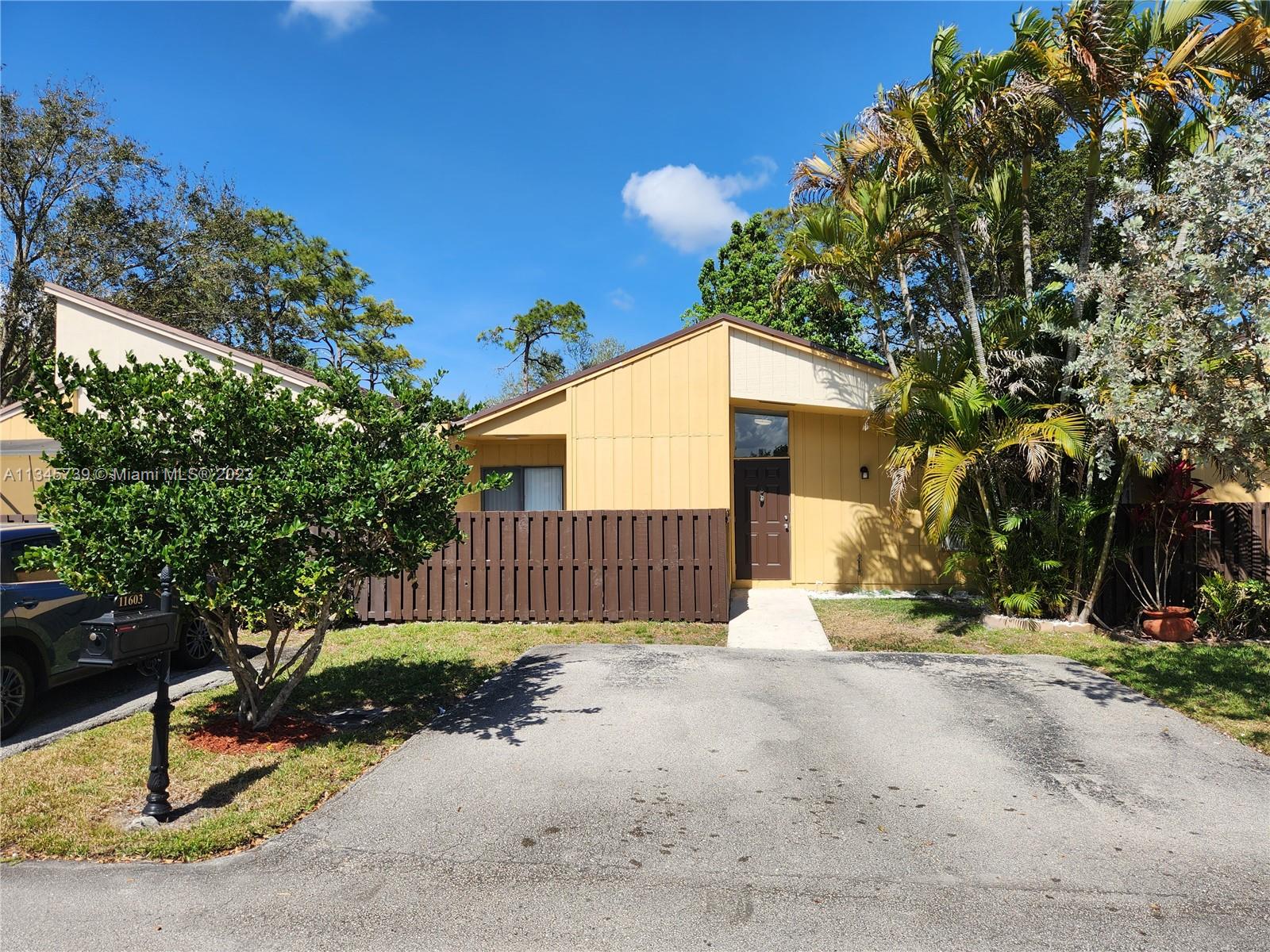 11603 Timbers Way Boca Raton, FL 33428 - Photo 40 of 48 a front view of a house with a yard