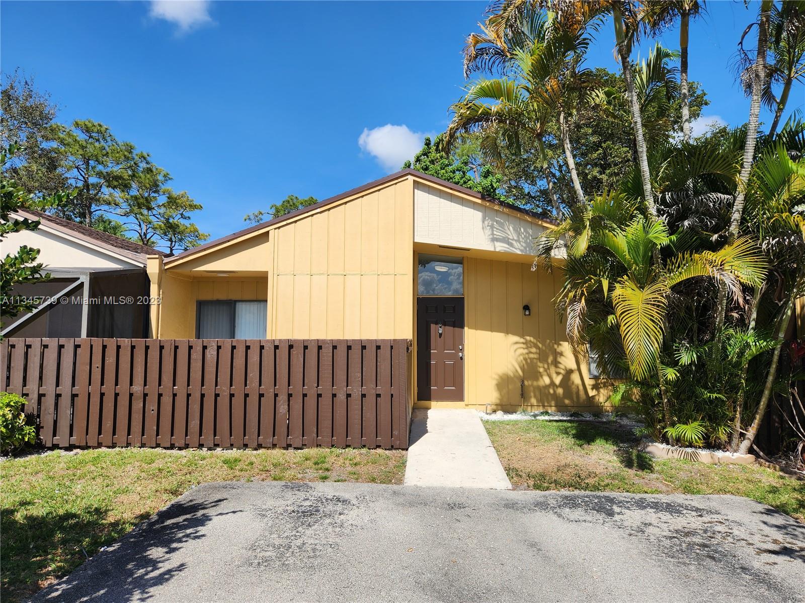 11603 Timbers Way Boca Raton, FL 33428 - Photo 41 of 48 a view of a wooden fence next to a yard
