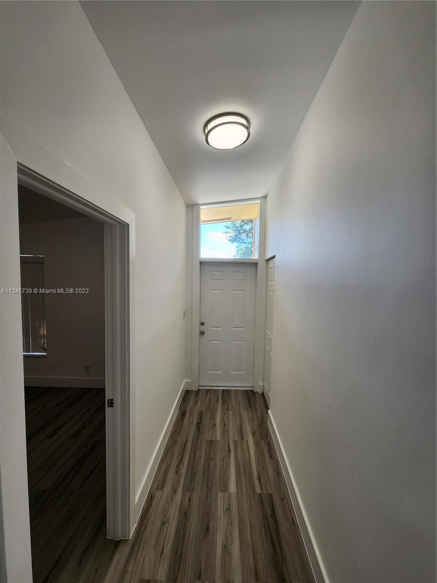 11603 Timbers Way Boca Raton, FL 33428 - Photo 7 of 48 a view of a hallway with wooden floor