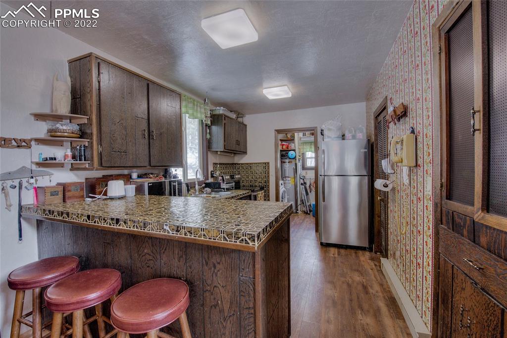 176 Cheyenne Road Alma, CO 80420 - Photo 15 of 50 a kitchen with stainless steel appliances granite countertop a sink refrigerator and cabinets