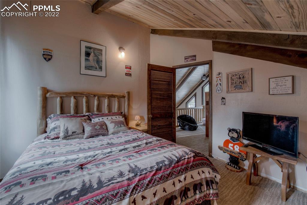 176 Cheyenne Road Alma, CO 80420 - Photo 30 of 50 a bedroom with bed and a fireplace