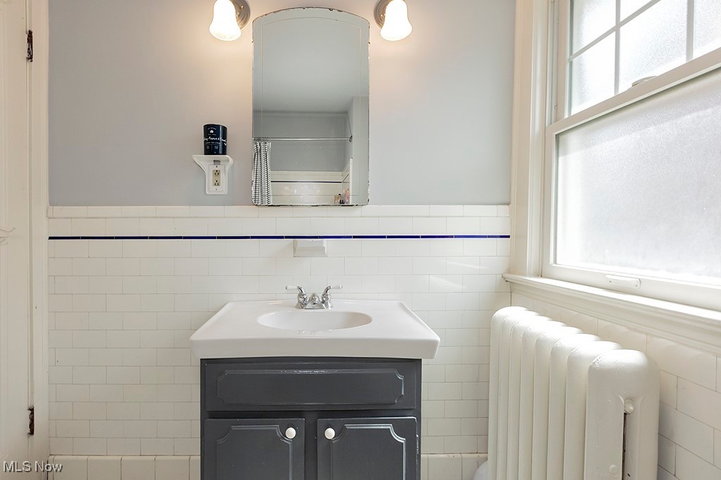 3256 Aberdeen Road Cleveland, OH 44120 - Photo 36 of 46 Bathroom with a wealth of natural light, tile walls, vanity, and radiator