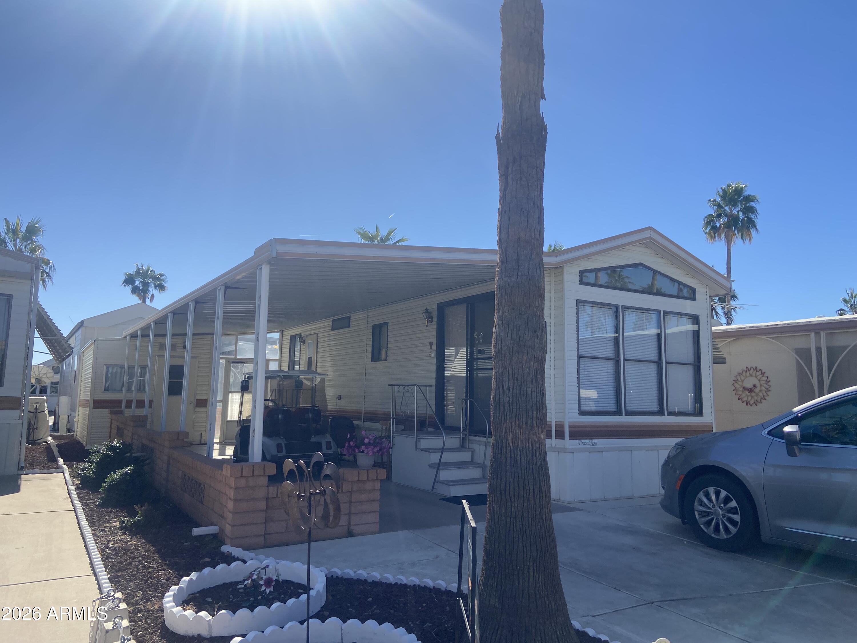 1328 West Inuit Avenue Apache Junction, AZ 85119 - Photo 15 of 45 a front view of a house with parking space