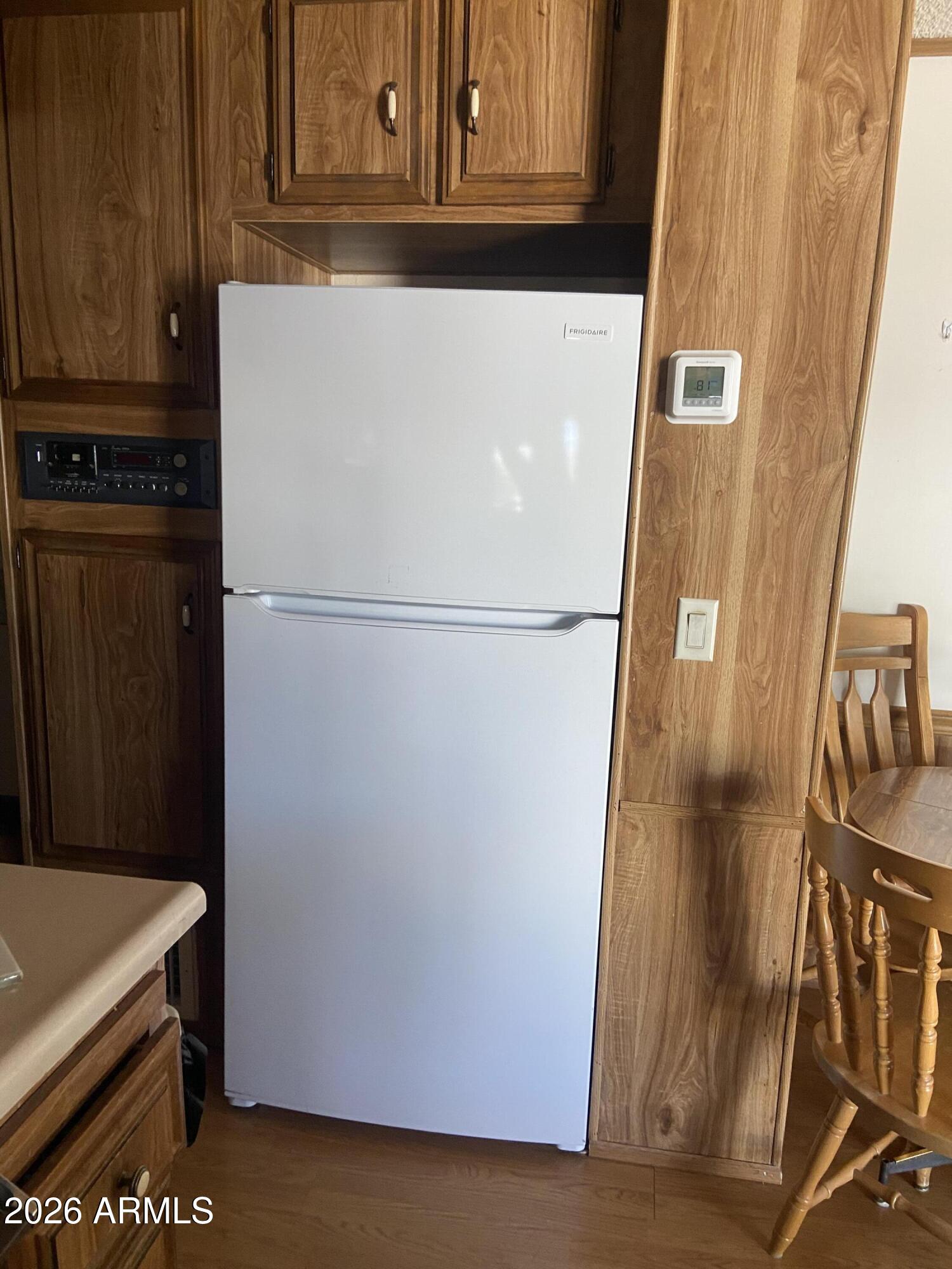 1328 West Inuit Avenue Apache Junction, AZ 85119 - Photo 31 of 45 a white refrigerator freezer sitting in a kitchen