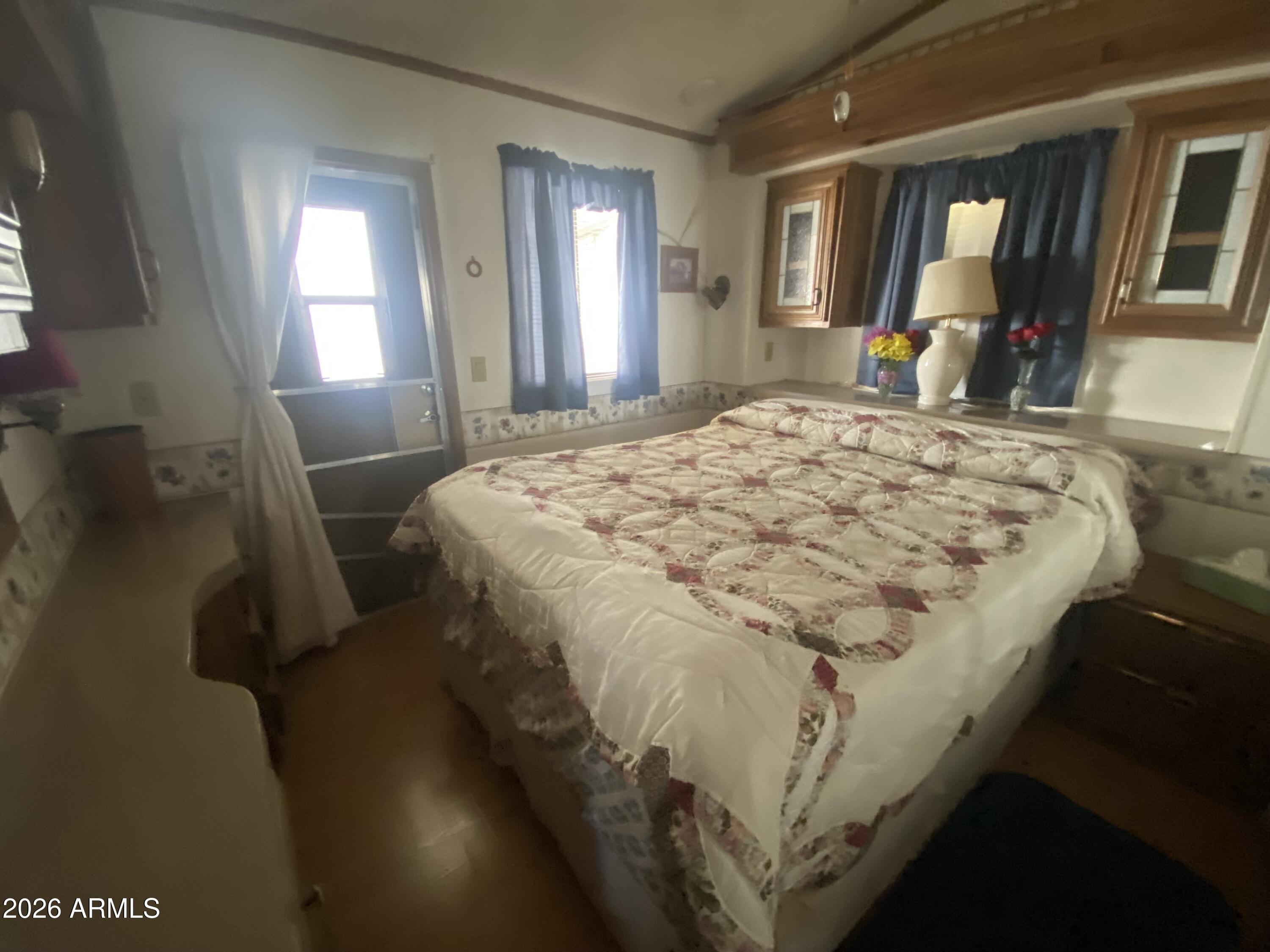 1328 West Inuit Avenue Apache Junction, AZ 85119 - Photo 35 of 45 a bed sitting in a bedroom next to a window