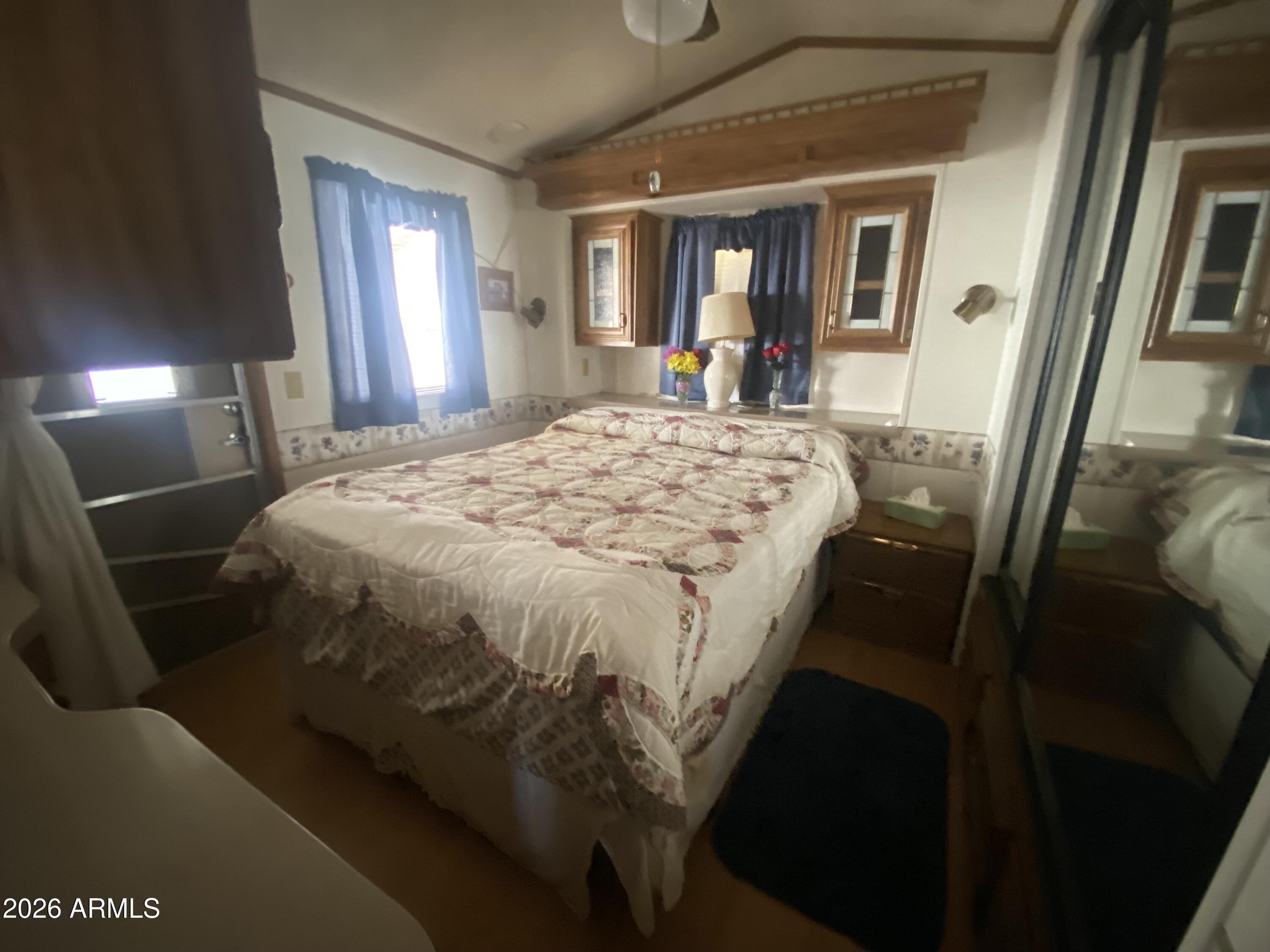 1328 West Inuit Avenue Apache Junction, AZ 85119 - Photo 36 of 45 a bed sitting in a bedroom next to a window