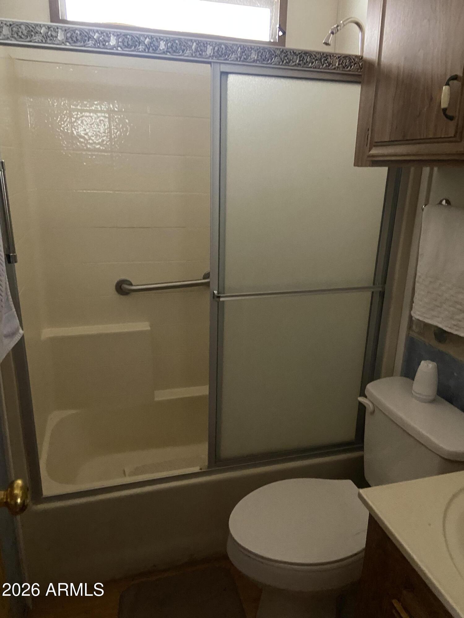 1328 West Inuit Avenue Apache Junction, AZ 85119 - Photo 39 of 45 a bathroom with a toilet and a shower