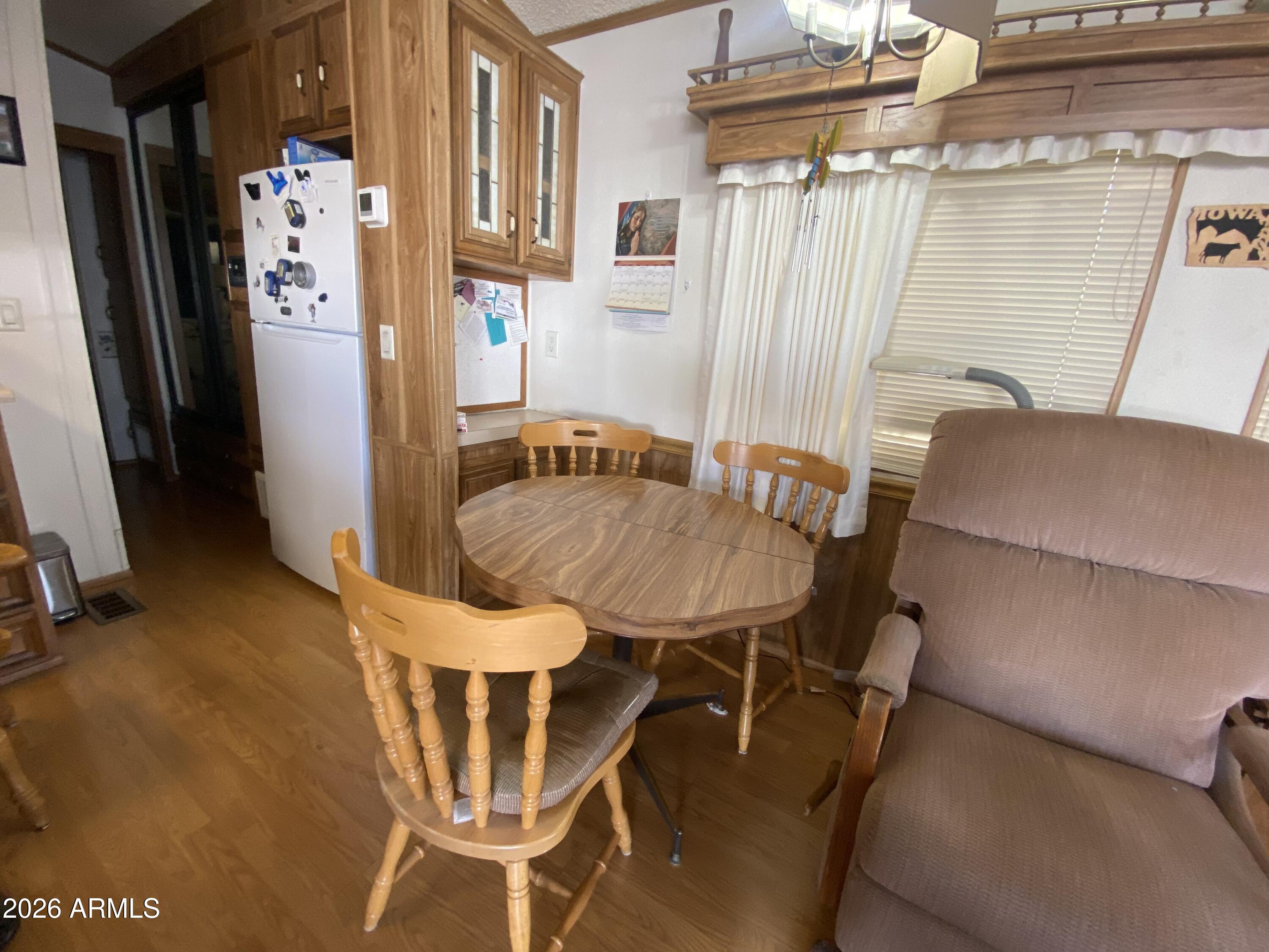 1328 West Inuit Avenue Apache Junction, AZ 85119 - Photo 5 of 45 a dining room with furniture and a chandelier