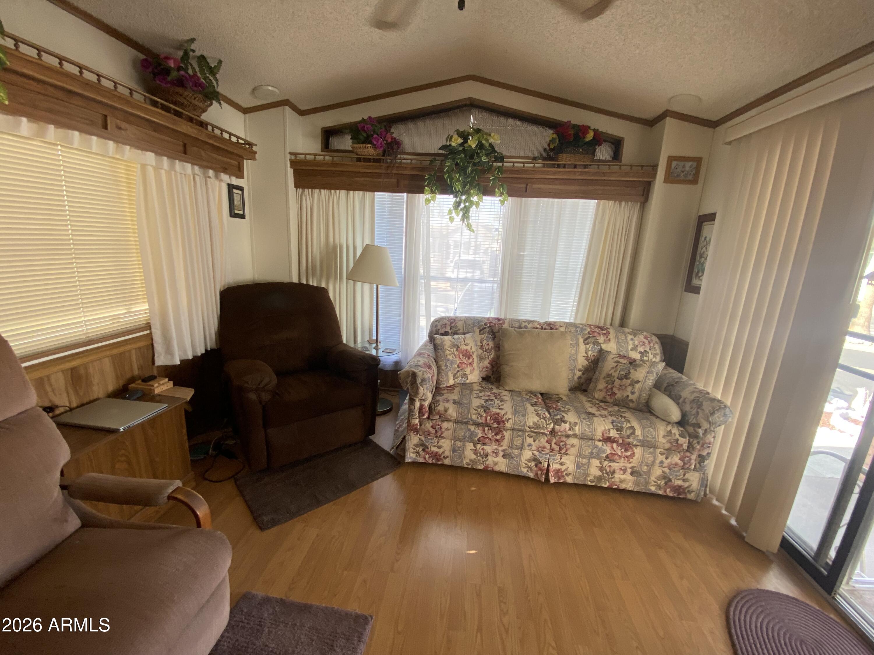 1328 West Inuit Avenue Apache Junction, AZ 85119 - Photo 8 of 45 a living room with furniture and a large window