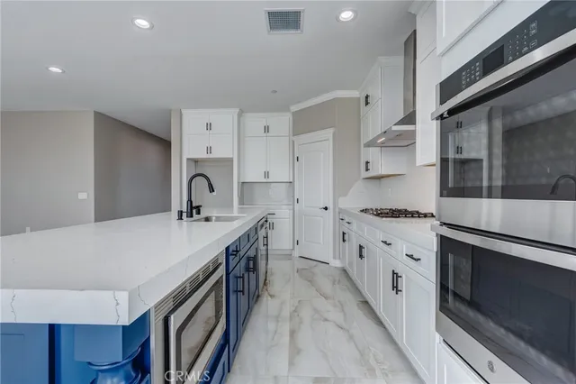 a kitchen with granite countertop a sink stove and cabinets