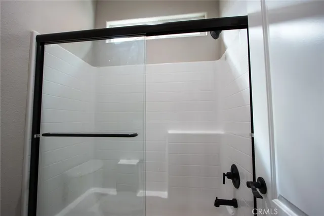 a bathroom with a glass shower door