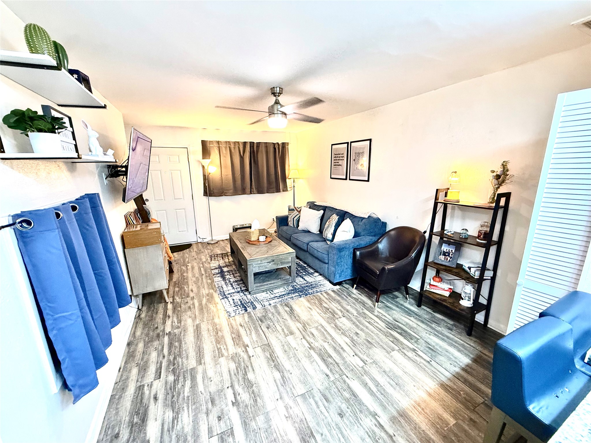 2413 Leon Street, Unit 108 Austin, TX 78705 - Photo 6 of 22 Living area featuring wood finished floors and a ceiling fan