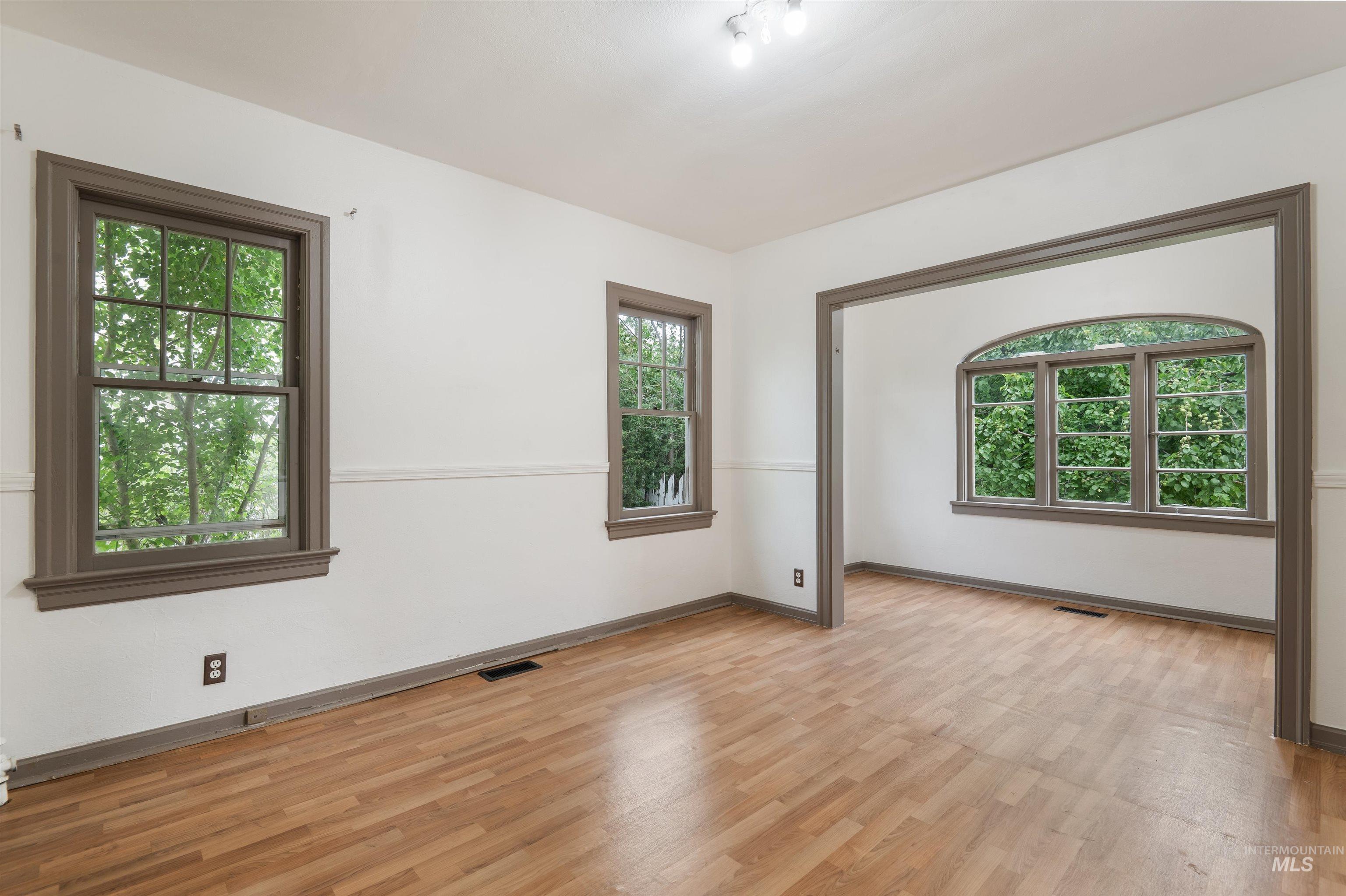 191 Southwest 5th Avenue Ontario, OR 97914 - Photo 11 of 50 Empty room with healthy amount of natural light and light wood-style floors
